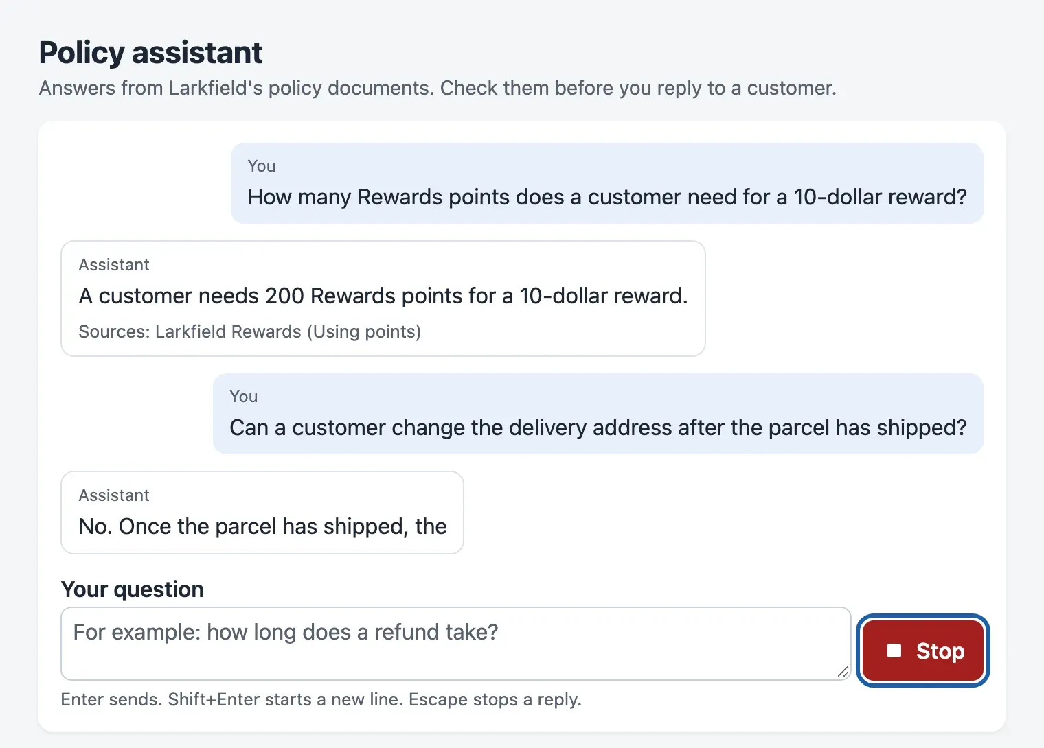 The finished chat while the second reply is written. Above the message box, the label Your question. The message box is still active. On its right, a red button with a square icon and the word Stop has a blue focus outline. Below, the hint: Enter sends. Shift+Enter starts a new line. Escape stops a reply. The labels You and Assistant and the sources line are dark grey.